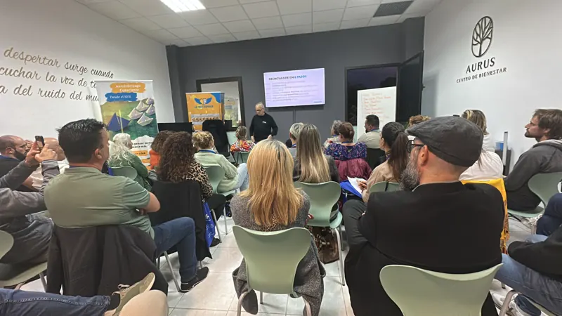 Sala del Centro Aurus llena de personas durante una charla
